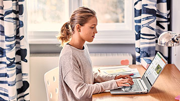 A girl, working on a laptop